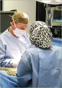 Dr. William Hedden and surgical assistant perform surgery